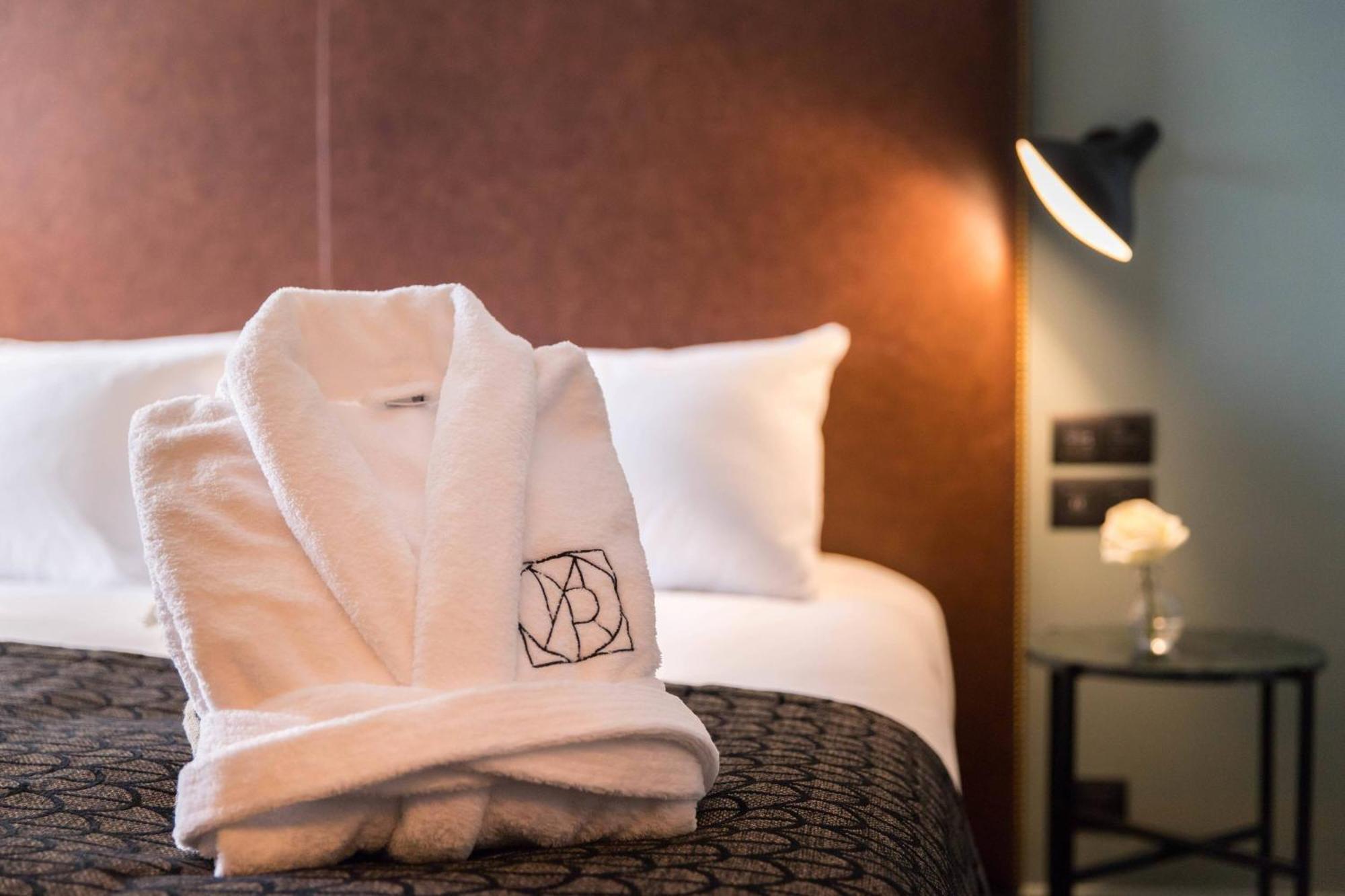 Maison Rouge Strasbourg Hotel & Spa, Autograph Collection Exterior photo A bathrobe on a bed